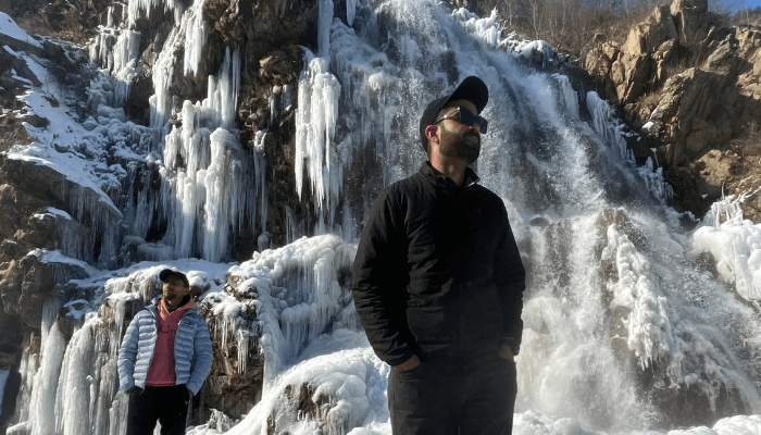 Snowy Drung Waterfall in Kashmir, an Instagramable winter destination with frozen cascades and scenic beauty.