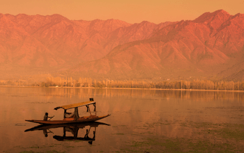 Scenic view of Kashmir’s Dal Lake with shikaras, showcasing beautiful places in Kashmir.